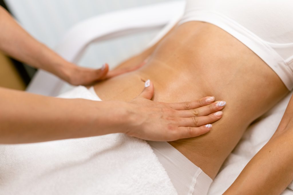 middle aged woman having a belly massage in a beauty salon.