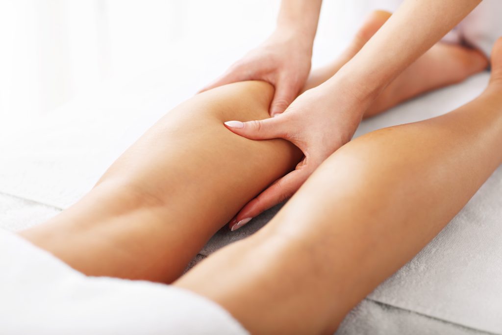 a picture of woman having leg therapy